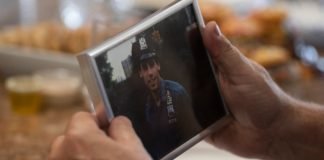 Bill Spade holds a photo of John D'Allara, who was a member of the NYPD Emergency Service Unit and died during the collapse of the North Tower on 9/11. (National Geographic/Virginia Sherwood)
